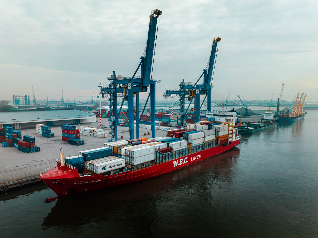 Dronefoto — overzicht van de kade met de WEC Van Gogh in de haven van Rotterdam